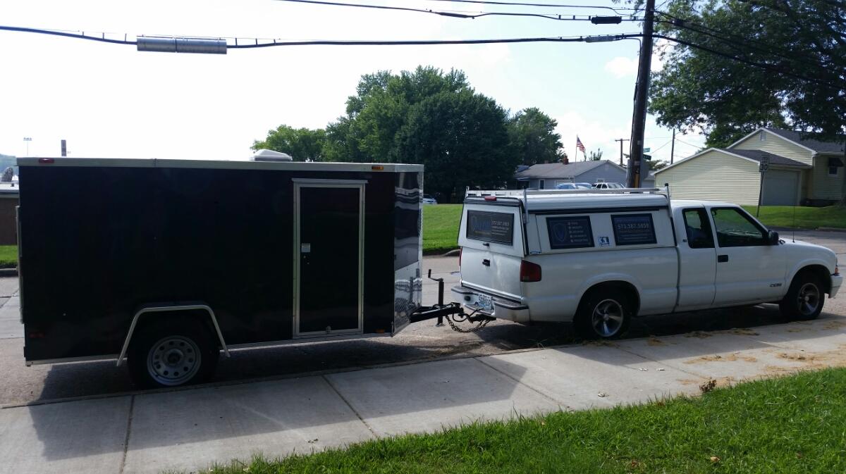 The Valor Pest Control truck and equipment trailer parked at a job